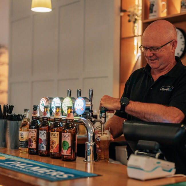 barman pouring a pint at the village inn
